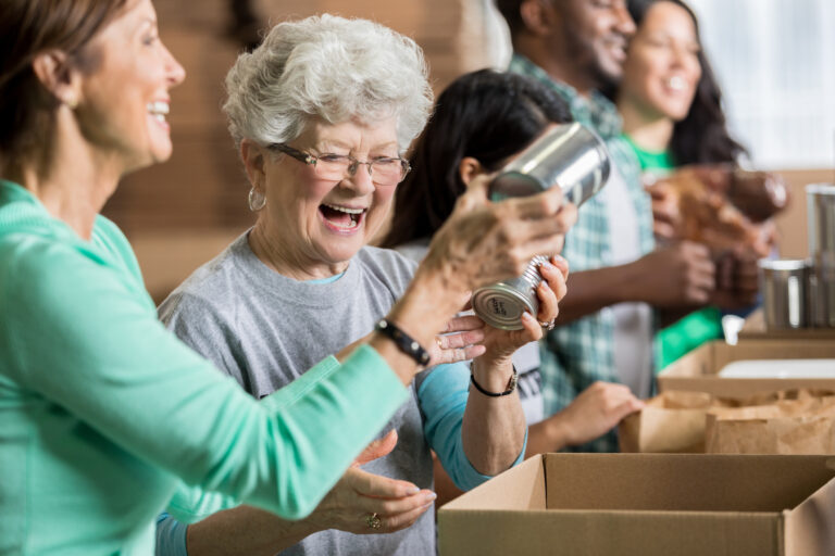 People smiling while working at a food bank