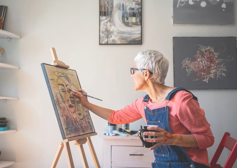 a woman painting in a studio