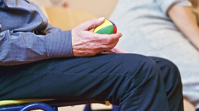 a man holding a small toy ball