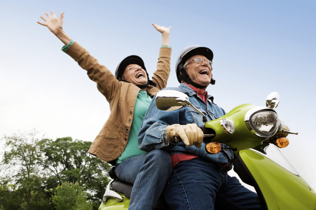 older adults enjoying life riding a motor bike
