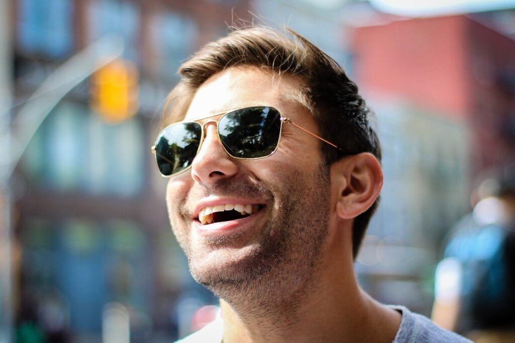 a man wearing sunglasses laughing