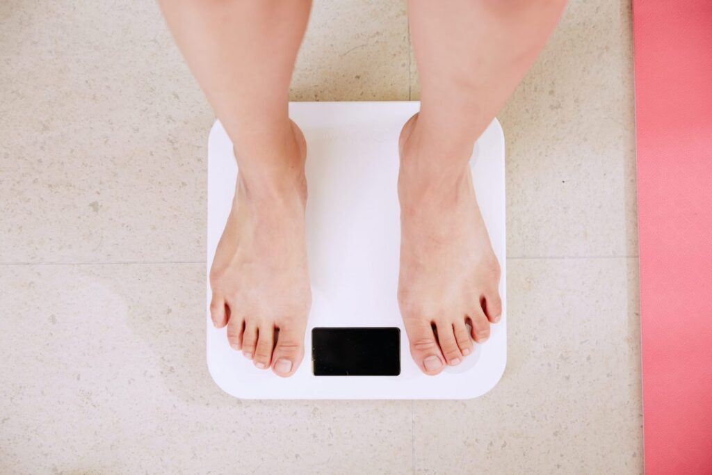a person weighing themself on a scale