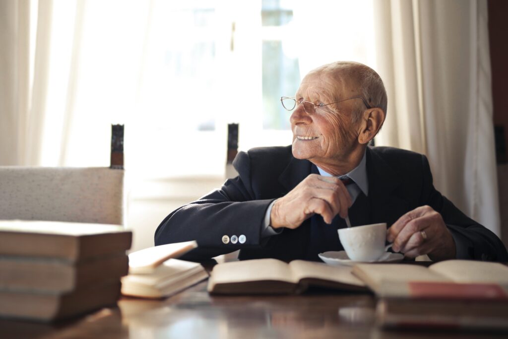 an elderly man eating breakfast